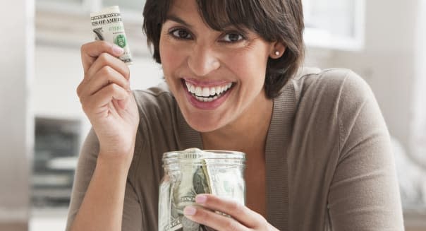 Woman with jar of cash