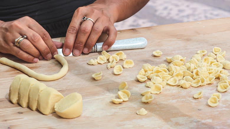 Freshly made orecchiette on wooden surface