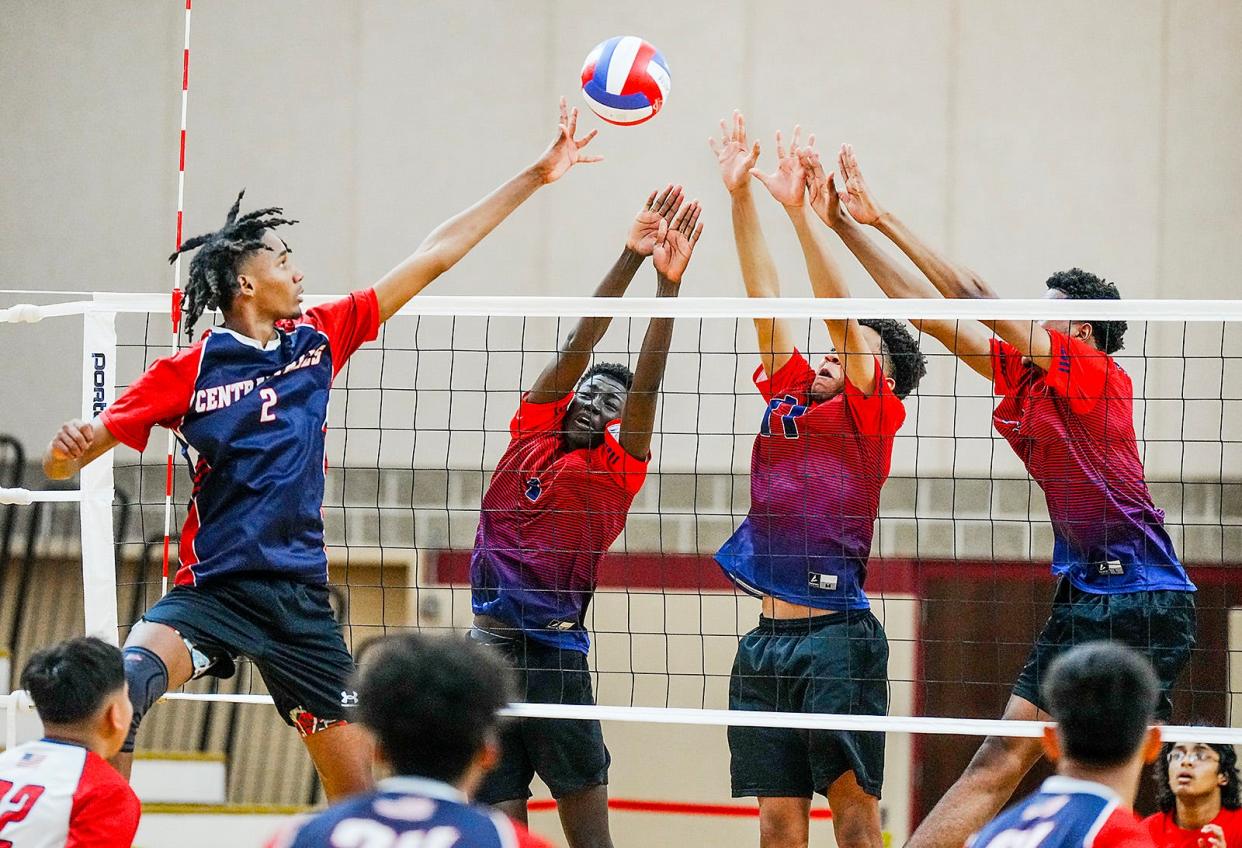 Central Falls' Jamilson De Pina Almeida, left, tips a ball over a trio of Pawtucket defenders in their championship match.