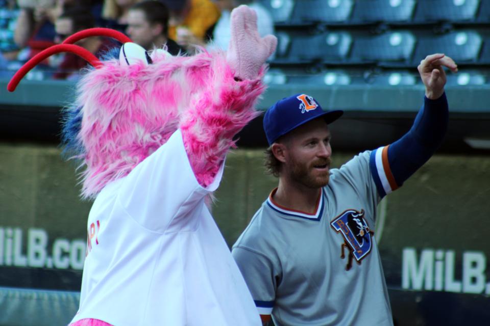 Durham Bulls outfielder Ben Gamel, a Bishop Kenny High School graduate, and Jacksonville Jumbo Shrimp mascot Scampi wave to fans before Tuesday's home opener.