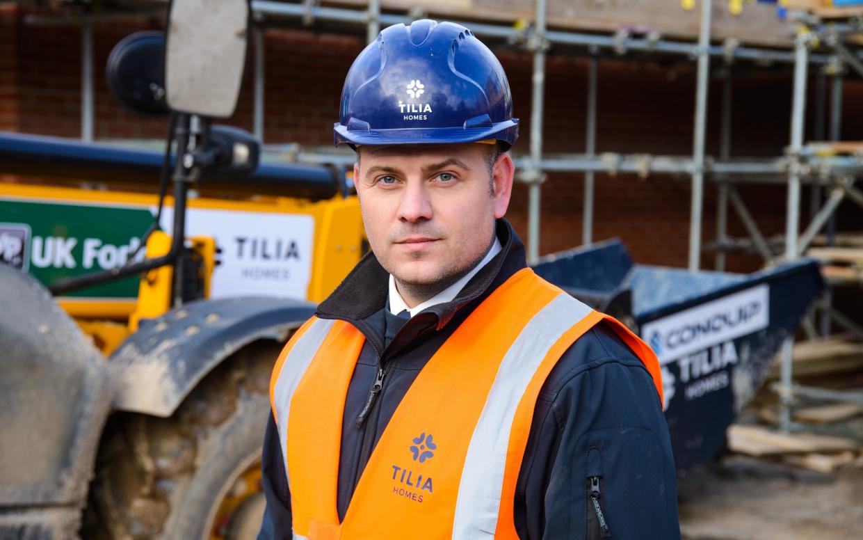 British army veteran Leon Calder wears hard hat and vest at construction site - Tony Buckingham