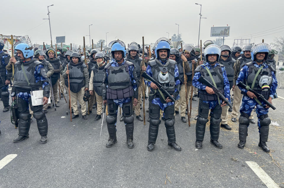 Police guard a major highway at Singhu near New Delhi to stop thousands of protesting farmers from entering the capital, India, Tuesday, Feb.13, 2024. Farmers, who began their march from northern Haryana and Punjab states, are asking for a guaranteed minimum support price for all farm produce. (AP Photo/Manish Swarup)