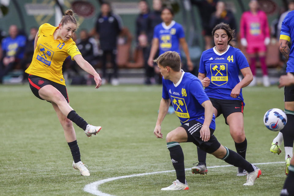 Portland Thorns midfielder Olivia Moultrie, left, of Team Yellow, takes a shot on goal during a coed charity match with Thorns and Portland Timbers players at Providence Park in Portland, Ore., Wednesday, April 27, 2022. It's been a little more than a year since Olivia Moultrie signed with the Portland Thorns after suing to join the National Women's Soccer League at just 15 years old. For Moultrie, the lasting lesson of her legal odyssey is that women should have the same opportunities to reach the top tier of U.S. pro soccer as men. Even if they're still teenagers.(Sean Meagher/The Oregonian via AP)