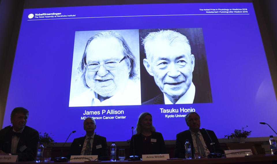 The Nobel prize laureate in medicine or physiology 2018 is shown on the screen James P Allison, left, and Tasuku Honjo, during the presentation at the Karolinska Institute in Stockholm, Sweden, Monday Oct. 1, 2018. The citation for this year's Nobel Prize in Medicine says the two honorees developed therapies for treating cancer. (Fredrik Sandberg/TT via AP)