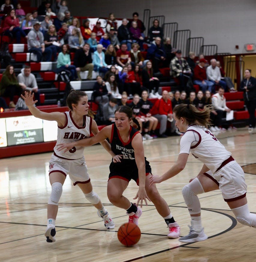 Roland-Story guard Claire Truesdell spits two South Hamilton defenders on her way to the basket during a 64-55 loss to the Hawks Jan. 10 at Jewell.