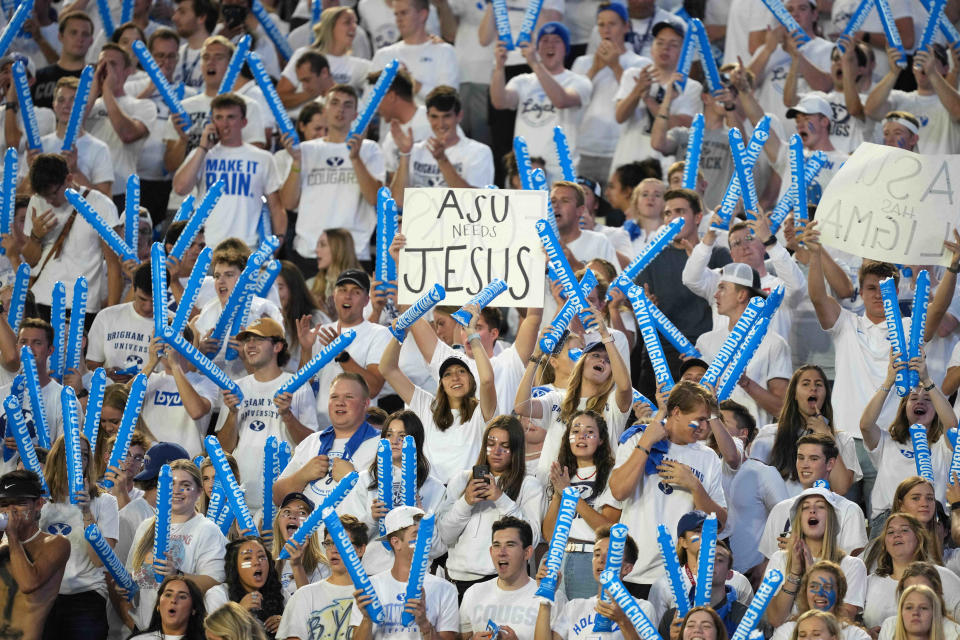 A BYU Cougars fan holds a sign that reads "ASU needs Jesus" during the game against the Arizona State Sun Devils at LaVell Edwards Stadium in Provo, Utah, on Sept. 18, 2021.