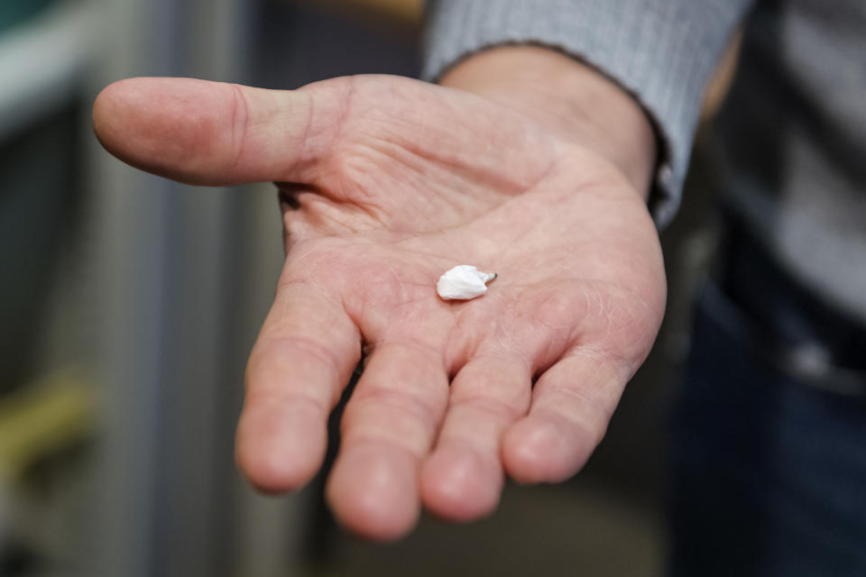 Chief police inspector of the Brussels Morolles neighbourhood, Kris Verborgh shows a package of crack cocaine in Brussels, Monday, Jan. 9, 2023. The white plastic-wrapped kernel found on a small-time dealer recently was barely the size of a fingernail and weighed all of 0.2 grams. The "flash" that crack provides though is increasingly felt through the Brussels Marolles neighborhood and any place in Europe where the surge in cocaine supply is hitting hard. (AP Photo/Geert Vanden Wijngaert)