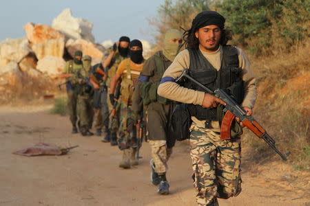 Members of al Qaeda's Nusra Front carry their weapons as they move towards their positions during an offensive to take control of the northwestern city of Ariha from forces loyal to Syria's President Bashar al-Assad, in Idlib province May 28, 2015. The Syrian army has pulled back from the northwestern city of Ariha after a coalition of insurgent groups seized the last city in Idlib province in northwestern Syria near the Turkish border that was still held by the government. REUTERS/Ammar Abdullah TPX IMAGES OF THE DAY