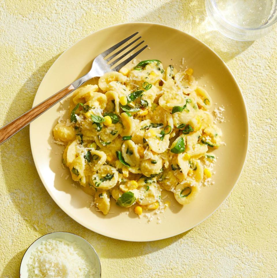 creamy corn pasta on a yellow plate