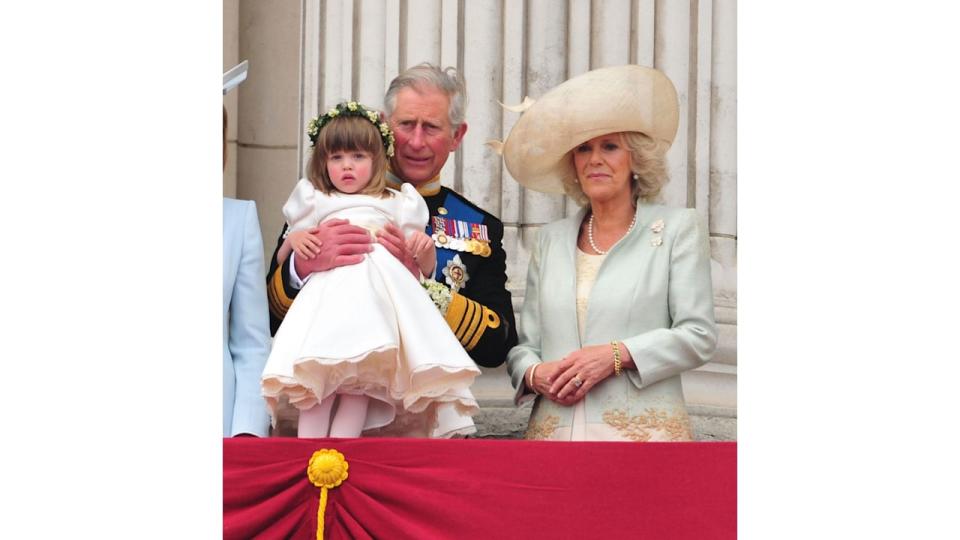 grandparents holding granddaughter