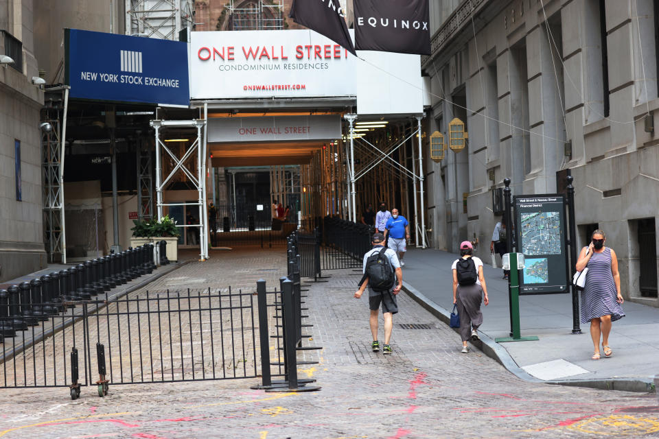 NEW YORK, NEW YORK - JULY 23: People walk along Wall Street near the New York Stock Exchange (NYSE) on July 23, 2020 in New York City. On Wednesday July 22, the market had its best day in 6 weeks. (Photo by Michael M. Santiago/Getty Images)