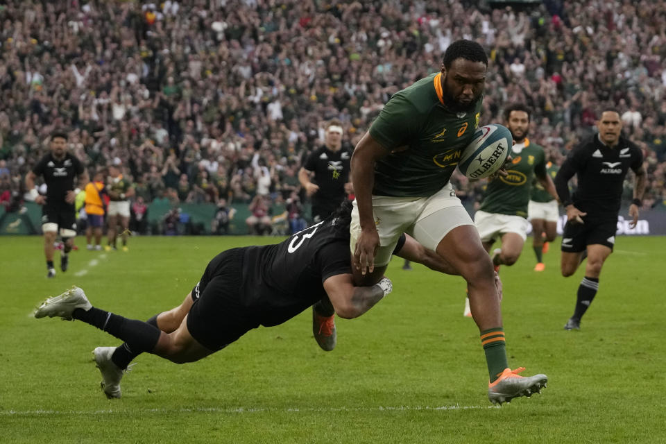 South Africa's Lukhanyo Am, right, is challenged by New Zealand's Rieko Ioane during the Rugby Championship test between South Africa and New Zealand at Ellis Park Stadium in Johannesburg, South Africa, Saturday, Aug. 13, 2022. (AP Photo/Themba Hadebe)