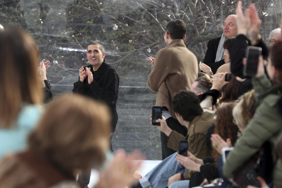 Designer Felipe Oliveira Baptista, center, accepts applause at the conclusion of the Kenzo fashion collection during Women's fashion week Fall/Winter 2020/21 presented in Paris, Wednesday, Feb. 26, 2020. (AP Photo/Thibault Camus)