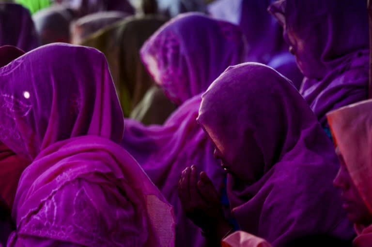 Rohingya women offer prayers at the 'widows' camp' were they have found refuge after fleeing violence in Myanmar