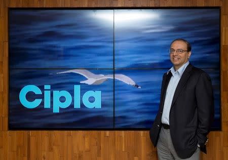Subhanu Saxena, CEO of Indian generic drugmaker Cipla, poses for a picture in front of company's logo at their headquarters in Mumbai, India June 17, 2015. REUTERS/Danish Siddiqui