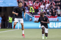 Portugal's Cristiano Ronaldo, left, and teammate Danilo Pereira warm up prior the Euro 2020 soccer championship group F match between Hungary and Portugal at the Ferenc Puskas stadium in Budapest, Hungary, Tuesday, June 15, 2021. (Bernadett Szabo/Pool via AP)