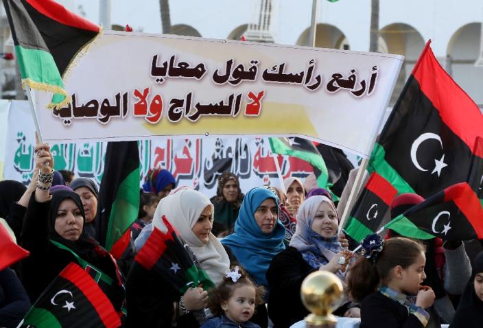 Libyans hold a banner reading in Arabic, "Lift your head and say no to Sarraj (Prime Minister-designate Fayez al-Sarraj); no to his rule," during a protest in Tripoli against the UN-backed unity government, on March 25, 2016 (AFP Photo/Mahmud Turkia)