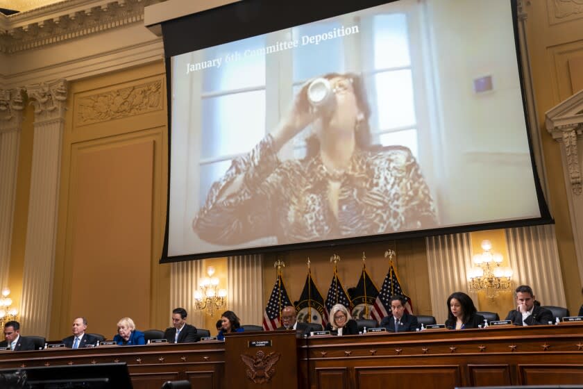 WASHINGTON, DC - JULY 12: Sidney Powell drinks a Diet Dr. Pepper in a video interview on screen during a House Select Committee to Investigate the January 6th Attack hearing in the Cannon House Office Building on Tuesday, July 12, 2022 in Washington, DC. The bipartisan Select Committee to Investigate the January 6th Attack On the United States Capitol has spent nearly a year conducting more than 1,000 interviews, reviewed more than 140,000 documents day of the attack. (Kent Nishimura / Los Angeles Times)