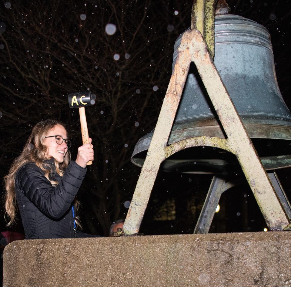 Kennady McClellan, an elementary language arts student at Adrian College, readies to strike the Victory Bell Nov. 16, 2022, during the college's ceremony of recognizing 10 teacher education students who completed the State of Michigan MTTC test, also known as the Michigan Tests for Teacher Certification.