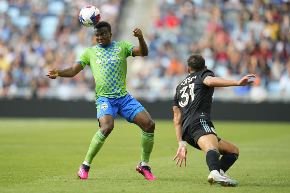 Seattle Sounders defender Nouhou Tolo, left, heads the ball as Minnesota United midfielder Hassani Dotson (31) defends during the second half of an MLS soccer match, Sunday, Aug. 27, 2023, in St. Paul, Minn. (AP Photo/Abbie Parr)