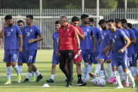 Portuguese Carlos Queiroz, center, head coach of Iran's national soccer team walks among players during a training session, in National Soccer Center in Tehran, Iran, Wednesday, Sept. 14, 2022. Queiroz was rehired as Iran coach on Sept. 7, to take the national soccer team to its third straight World Cup, where the squad will face the United States, England and Wales in the first round. (AP Photo/Vahid Salemi)