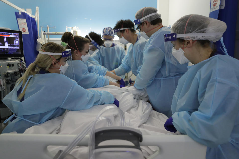 Critical Care staff prone a COVID-19 patient on the Christine Brown ward at King's College Hospital in London, Wednesday, Jan. 27, 2021. The scale of Britain's coronavirus outbreak can seem overwhelming, with tens of thousands of new infections and more than 1,000 deaths added each day. But on hospitals' COVID-19 wards, the pandemic feels both epic and intimate, as staff fight the virus one patient at a time, and with no end in sight. (AP Photo/Kirsty Wigglesworth, pool)