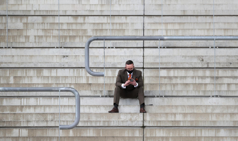 <p>An owner sits in isolation in the stands at Cheltenham Racecourse. Picture date: Thursday April 15, 2021.</p>
