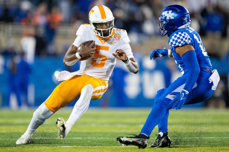 Tennessee quarterback Hendon Hooker (5) runs around Kentucky linebacker Jacquez Jones (10) during the second quarter of their 2021 game at Kroger Field.