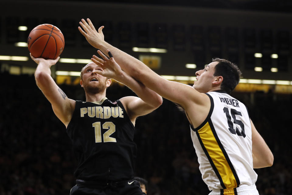 Purdue forward Evan Boudreaux shoots next to Iowa forward Ryan Kriener, right, during the first half of an NCAA college basketball game Tuesday, March 3, 2020, in Iowa City, Iowa. (AP Photo/Charlie Neibergall)