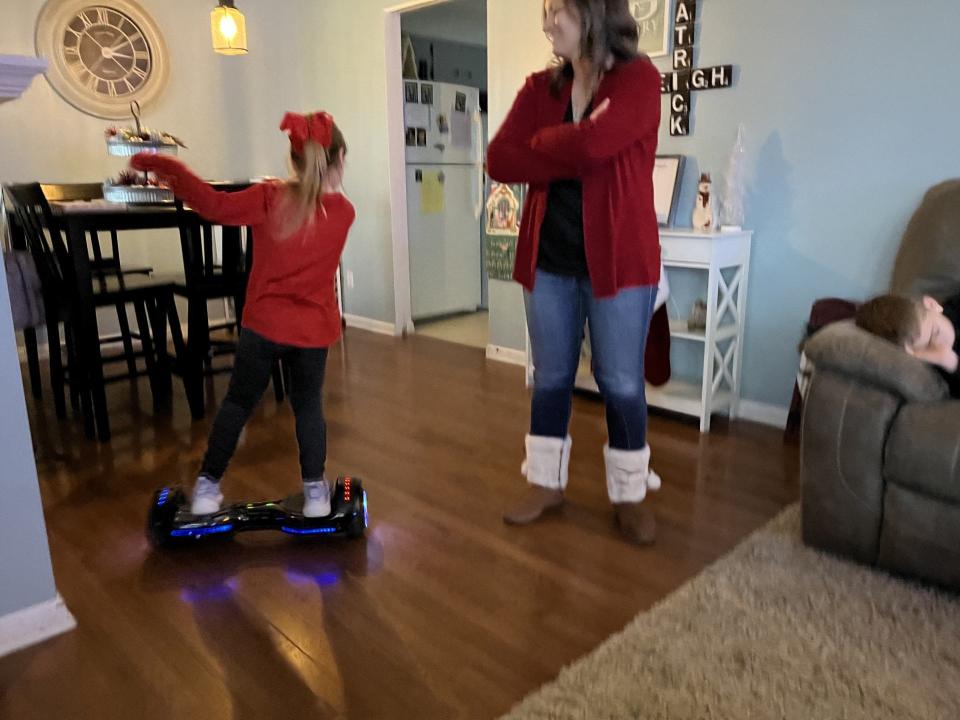 Harleigh Berry demonstrates her hoverboard skills under the watchful eyes of her mother, Ashleigh, at the family's Peoria home.