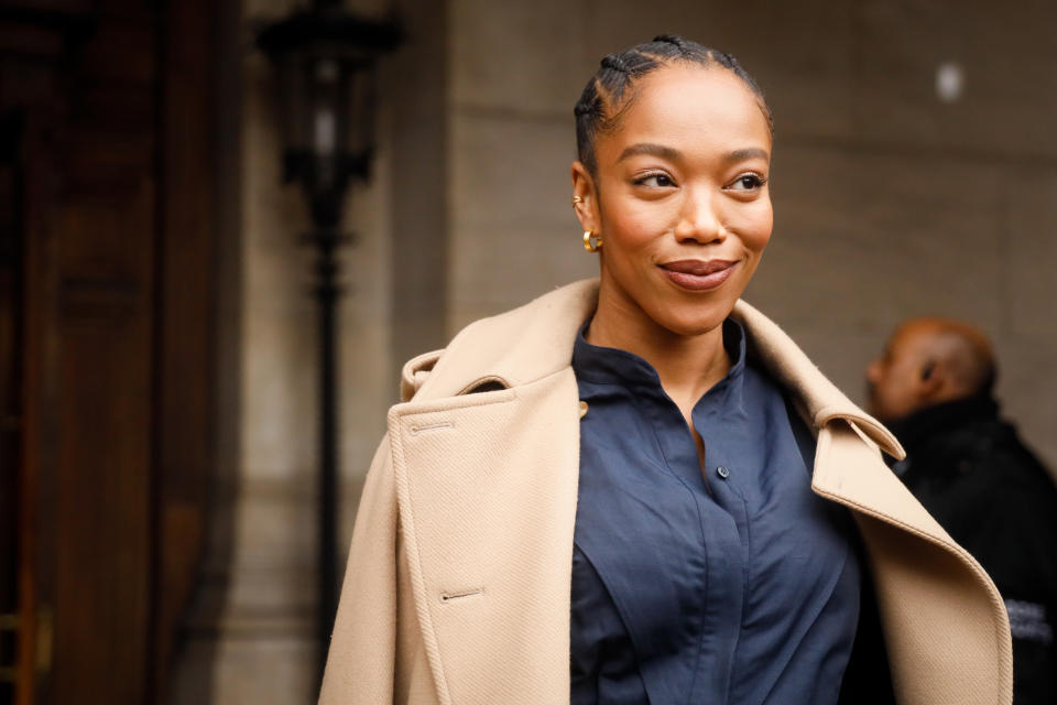 PARIS, FRANCE - MARCH 02: Naomi Ackie wearing Stella McCartney trench coat, navy shirt green stilettos and baby blue leather bag  outside Stella McCartney during Paris Fashion Week Womenswear Fall/Winter 2020/2021 Day Eight on March 02, 2020 in Paris, France. (Photo by Hanna Lassen/Getty Images)