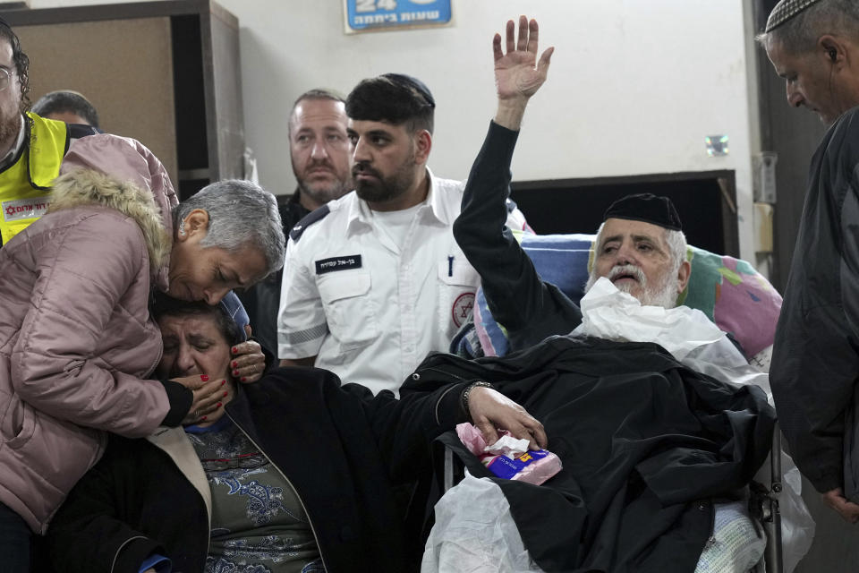 The parents of Tamir Avihai, 50, are comforted at his funeral in the West Bank Israeli settlement of Barkan, Tuesday, Nov. 15, 2022. A Palestinian killed three Israelis, including Avihai and wounded three others in an attack in a settlement in the occupied West Bank on Tuesday before he was shot and killed by Israeli security personnel, Israeli paramedics and Palestinian officials said. (AP Photo/ Tsafrir Abayov)