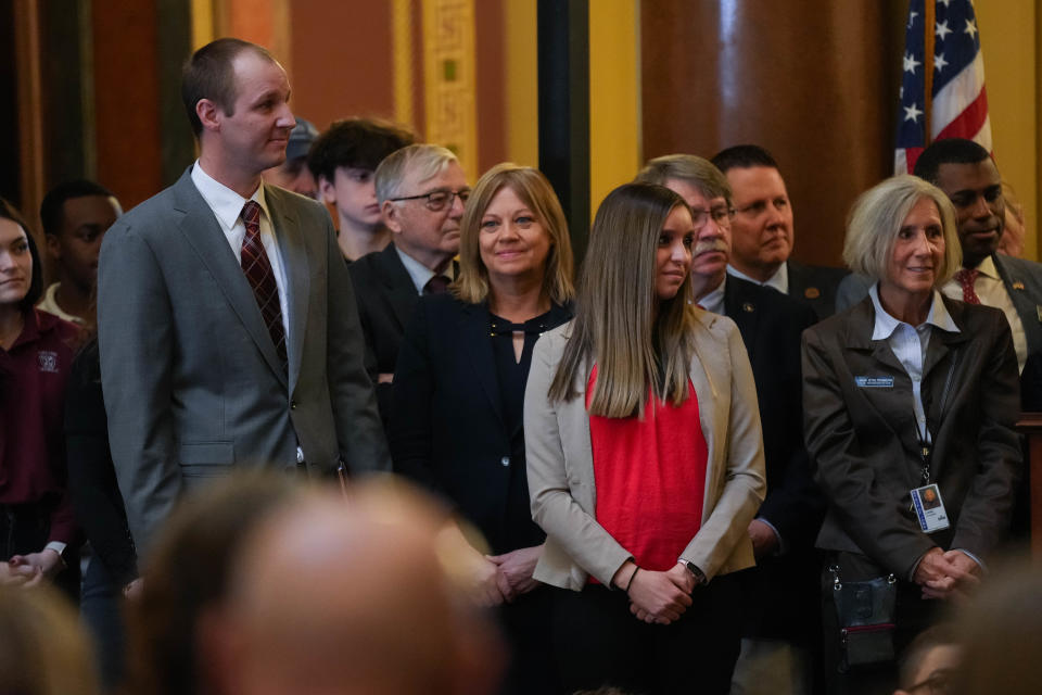 Head of Schools at Pella Christian Schools Dan Zylstra, left, and Executive Director of Hispanics Aligned for Choice in Education Reform Arlene McClintock are introduced by Gov. Kim Reynolds before they gave their testimonies at the signing of Reynolds' "school choice" legislation in the rotunda of the Iowa State Capitol Building on Tuesday, Jan. 24, 2023.