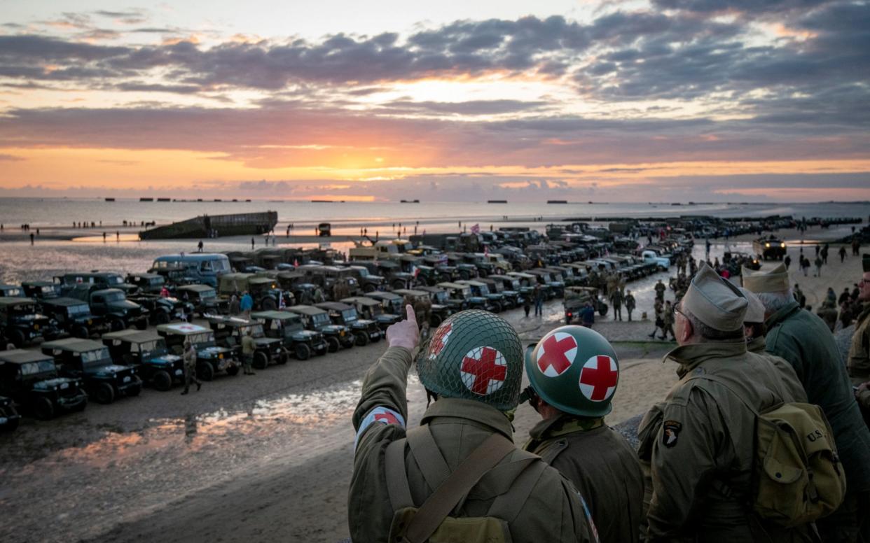 Re-enactors overlook the vehicles gathered on Gold Beach as part of the 75th anniversary of D-Day - Geoff Pugh