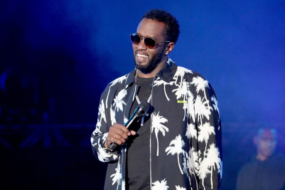 Diddy looks amazing with a bright smile on his face as he addresses a crowd. 