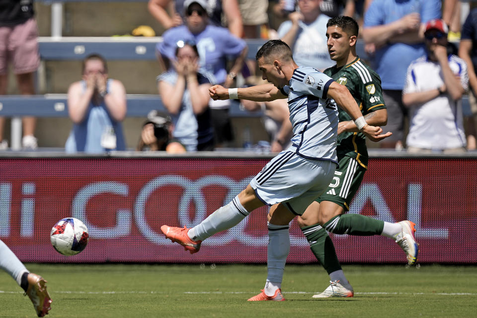 Sporting Kansas City midfielder Erik Thommy gets past Portland Timbers defender Claudio Bravo (5) to kick for a goal during the first half of an MLS soccer match Sunday, May 28, 2023, in Kansas City, Kan. (AP Photo/Charlie Riedel)