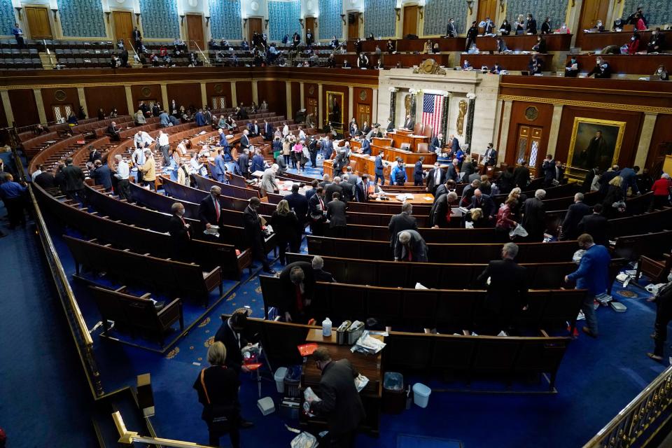 House members prepare to leave the floor as protesters try to break into the House Chamber at the U.S. Capitol on Wednesday, Jan. 6, 2021, in Washington.