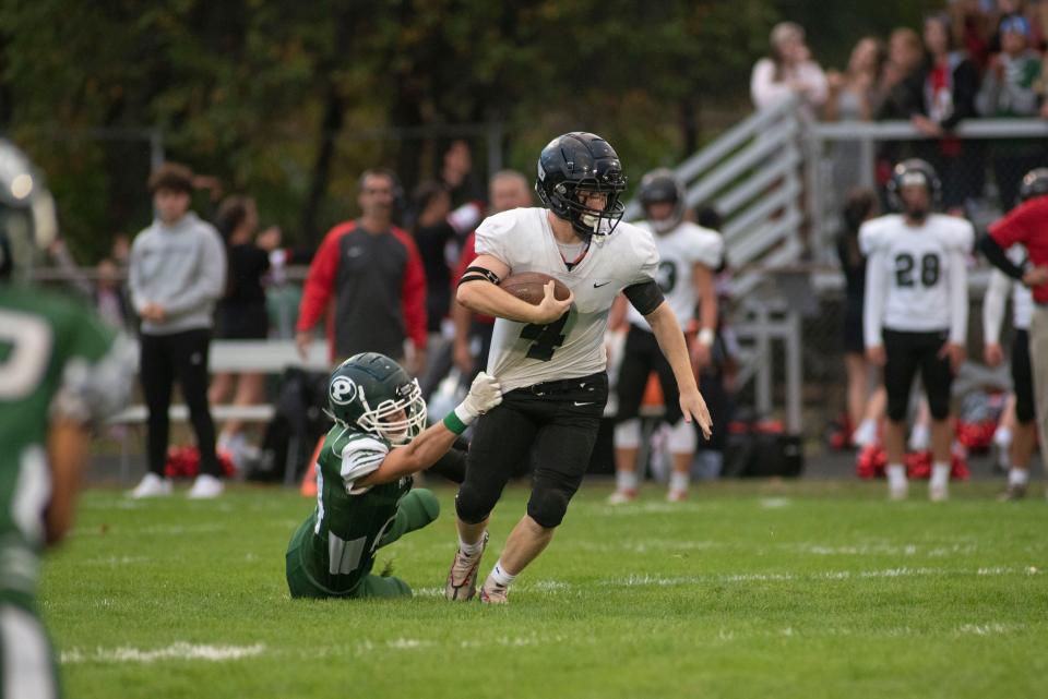 Pennfield junior Brayden Sturhan dives for Marshall senior Luke Holbrook during a game at Pennfield High School on Friday, Sept. 23, 2022.