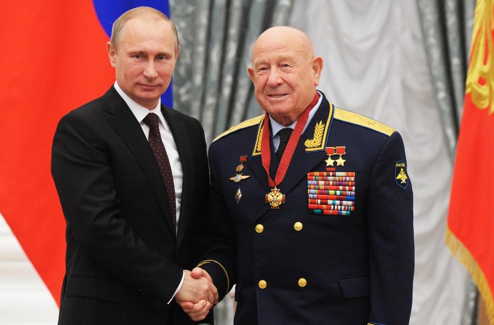 FILE - In this Friday, June 14, 2013 file photo, Russian cosmonaut Alexei Leonov, who made the first spacewalk in 1965, right, and Russian President Vladimir Putin pose for a photo in the Novo-Ogaryovo residence outside Moscow, Russia. Alexei Leonov, the first human to walk in space, died in Moscow on Friday, Oct. 11, 2019. He was 85. (Mikhail Klimentyev, Sputnik, Kremlin Pool Photo via AP, File)