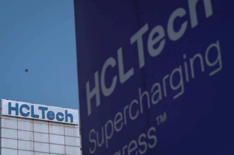 FILE PHOTO: A pigeon flies past a logo of HCL Technologies installed at their headquarters in Noida