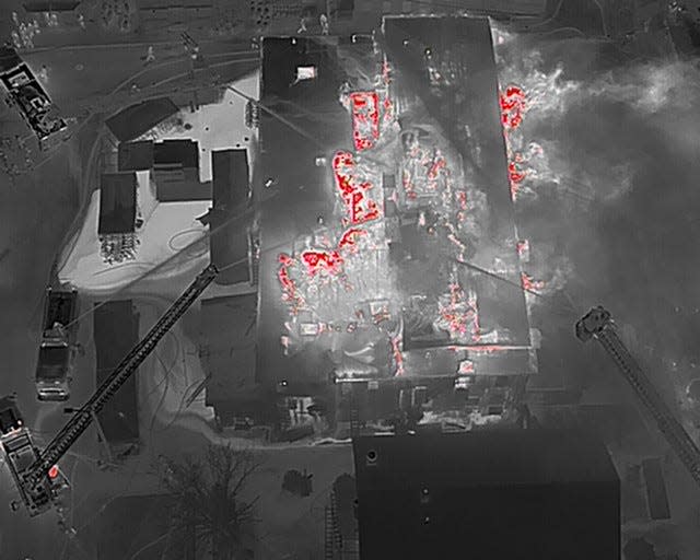 A aerial drone image taken with an infrared camera helped firefighters identify hot spots obscured by smoke.