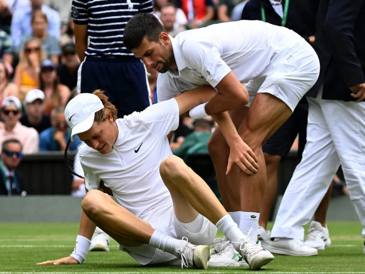 Novak Djokovic climbed over the net and picked up his opponent after he took a h..