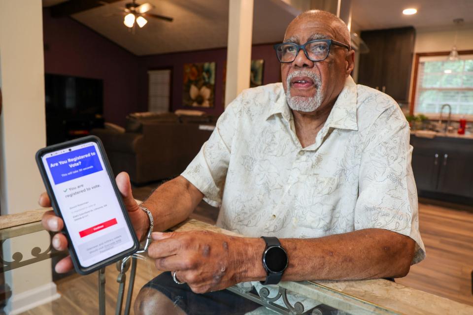 Donel Peterman, 70, shows the site to check whether your voter registration is still in effect. Peterman helps educate voters after he says he was wrongly dropped from the rolls in 2017 under a Georgia law.