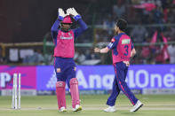 Rajasthan Royals' captain Sanju Samson, left, congratulates teammate Yuzvendra Chahal for taking the wicket of Gujarat Titans' captain Shubman Gill during the Indian Premier League cricket match between Gujarat Titans and Rajasthan Royals in Jaipur, India, Wednesday, April 10, 2024. (AP Photo/Surjeet Yadav)