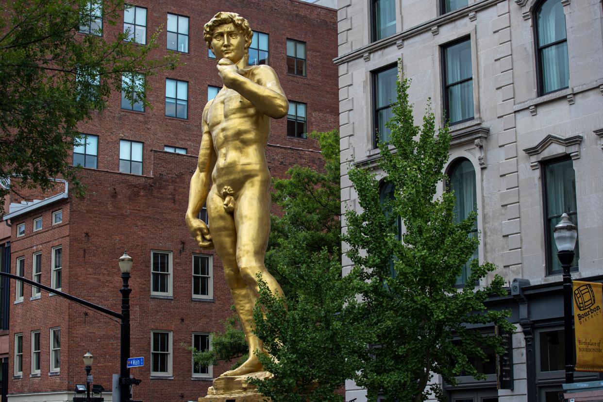 The supersized, gold painted recreation of the Michelangelo's 'David' stand on Main Street in Louisville, Kentucky in front of the 21c Hotel. June 30, 2020