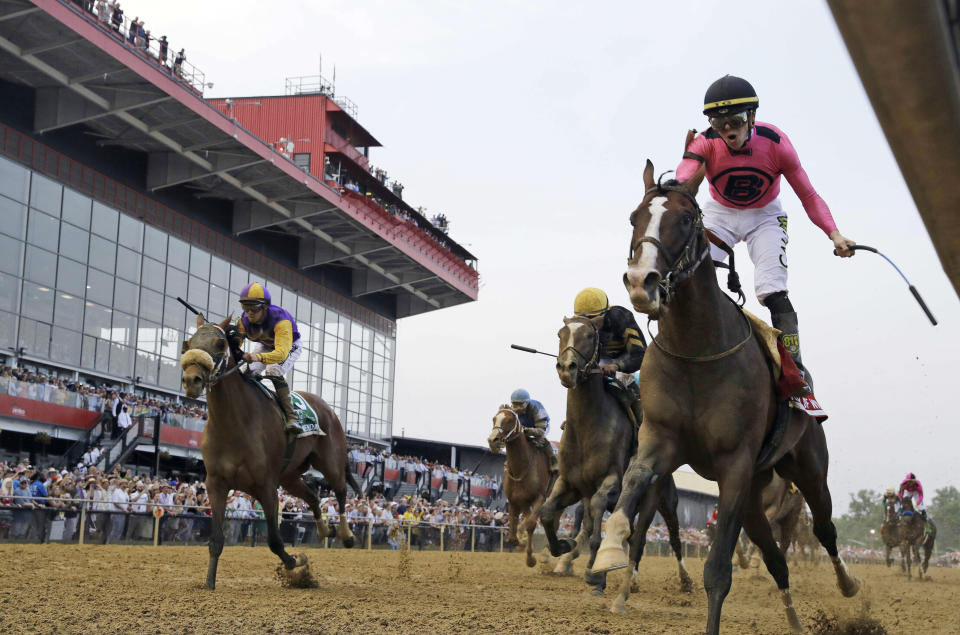 Jockey Tyler Gaffalione, right, reacts aboard War of Will, as they crosses the finish line first to win the Preakness Stakes horse race at Pimlico Race Course, Saturday, May 18, 2019, in Baltimore.(AP Photo/Steve Helber)