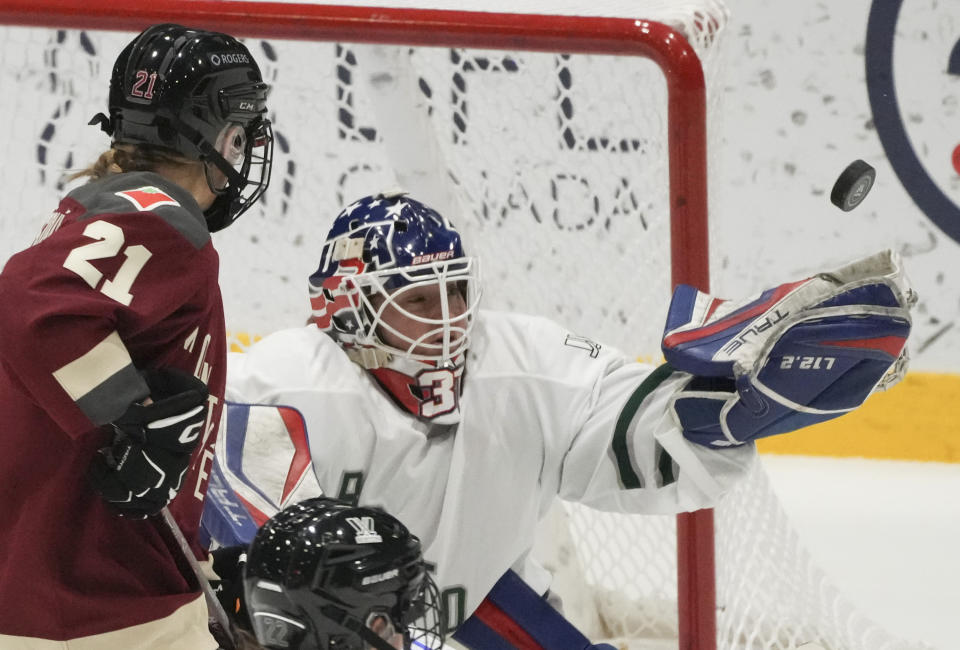 Boston goaltender Cami Kronish (35) makes a save as Montreal's Tereza Vanisova (21) looks for a rebound during the second period of a PWHL hockey game in Montreal, Saturday, Jan. 13, 2024. (Christinne Muschi/The Canadian Press via AP)