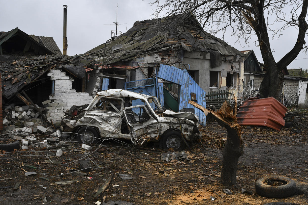 A damaged Soviet-era Ukrainian car "Zaporozhets" is seen next to a destroyed apartment building after Russian shelling in Pokrovsk, Donetsk region, Ukraine, Friday, Nov. 4, 2022. (AP Photo/Andriy Andriyenko)