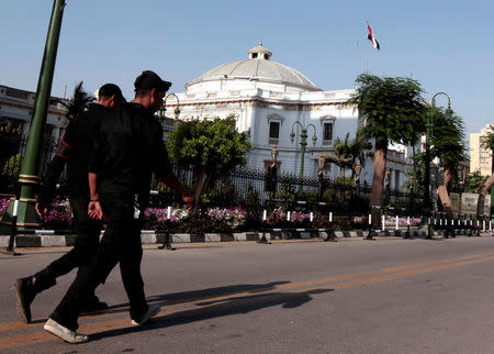 Members of the police force walk in front of the parliament building in Cairo, Egypt June 14, 2012. REUTERS/Mohamed Abd El Ghany/File Photo