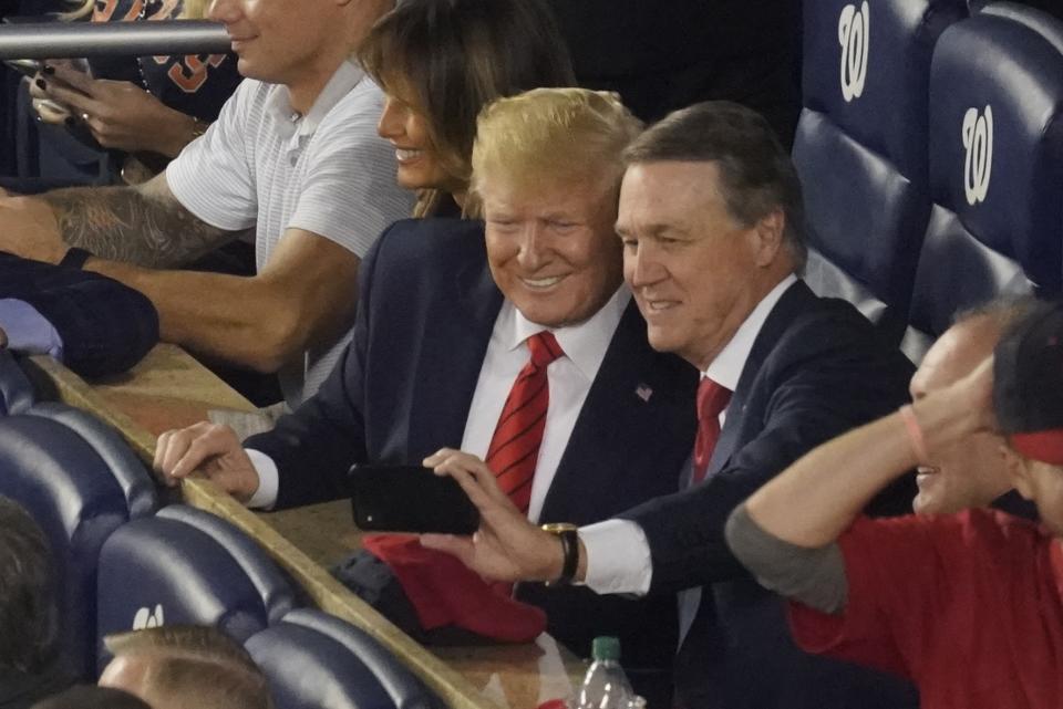 Sen. David Perdue, R-Ga., takes a selfie with President Donald Trump during the seventh inning of Game 5 of the baseball World Series between the Houston Astros and the Washington Nationals Sunday, Oct. 27, 2019, in Washington. (AP Photo/Pablo Martinez Monsivais)